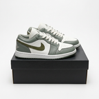 Grey and white Air Jordan 1 Low sneakers on a black shoe box