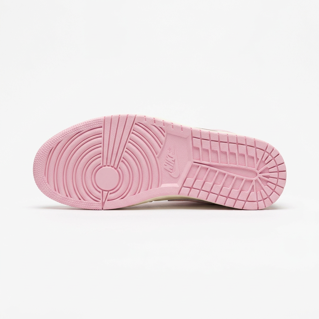 Pastel pink sneaker outsole with circular and block tread on white background