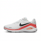 White Nike sneaker with black Swoosh and coral-red accents, side view on white
