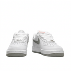 White and grey Nike Air Force 1 sneakers, front view on white background