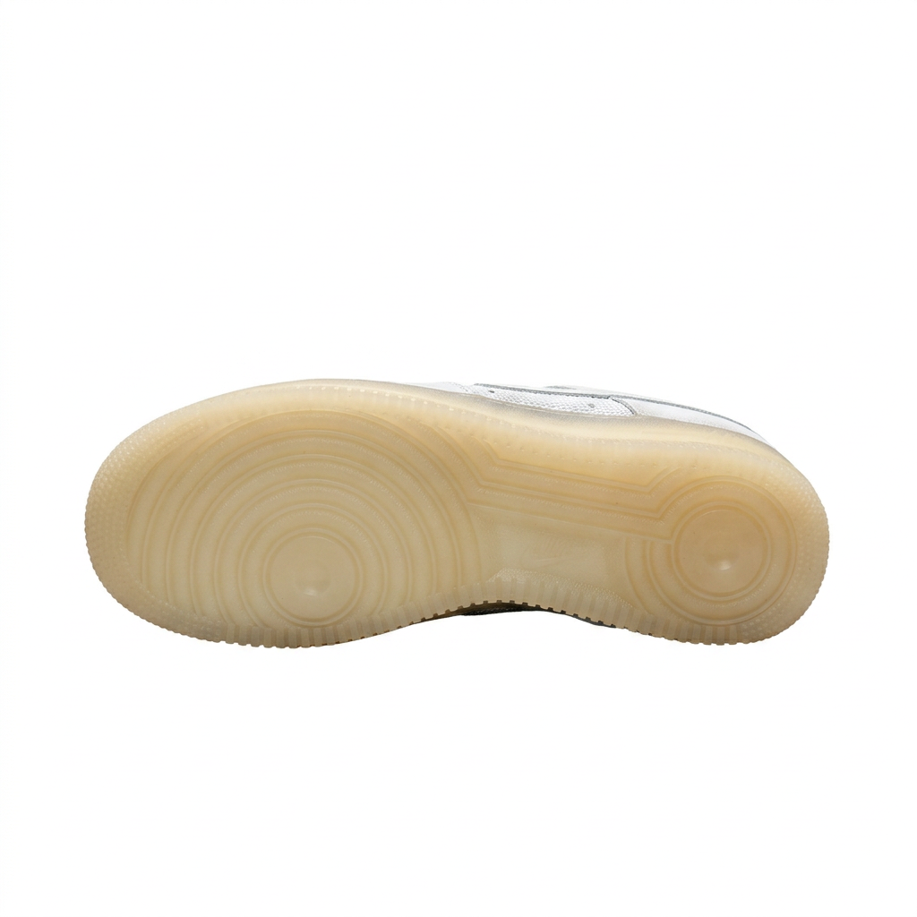Translucent pale yellow sneaker outsole with circular tread pattern on white.
