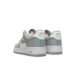 Grey and white Nike sneakers, rear view on white background