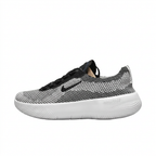 Left-facing black and white textured Nike sneaker with black Swoosh and thick white sole on white.