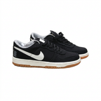 Black Nike sneaker pair with white Swooshes and gum outsoles, angled view on white background