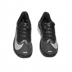 Black Nike sneakers with silver Swooshes, overhead view on white background
