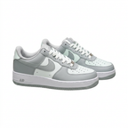 Grey and white Nike sneakers, angled side view on white background