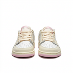 Cream white and pink sneakers with cream laces, front view on white