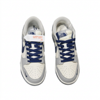 Grey and white sneakers with navy laces and perforated toes, overhead view on white background