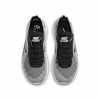Top view of black and white textured Nike sneakers with black tongues and laces on white.